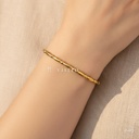 Pulsera dorada rígida, de esferas y barras