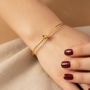 Pulsera dorada rígida, aro abierto con nudo central