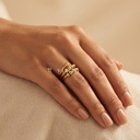 Anillo dorado abierto, diseño de espiral doble con esferas móviles y extremo rematado en esfera