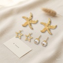 Set de tres pares de zarcillos dorados, estrella de mar, botón