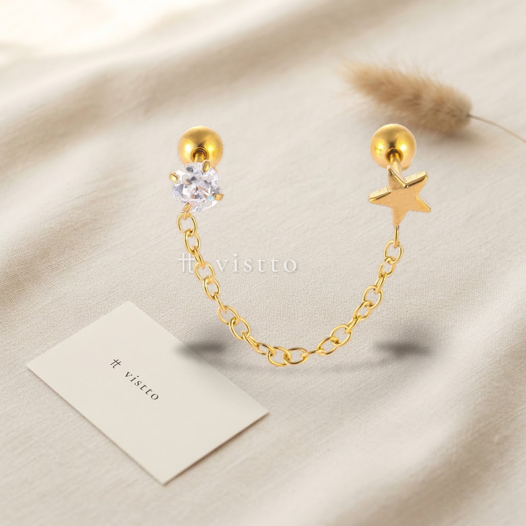 Zarcillos dorados de doble piercing unidos por cadena fina, con circonia transparente y motivo de estrella